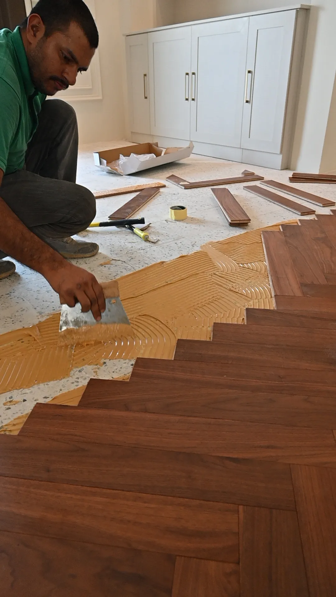 An Elite installer laying herringbone with laser-guided setting-out