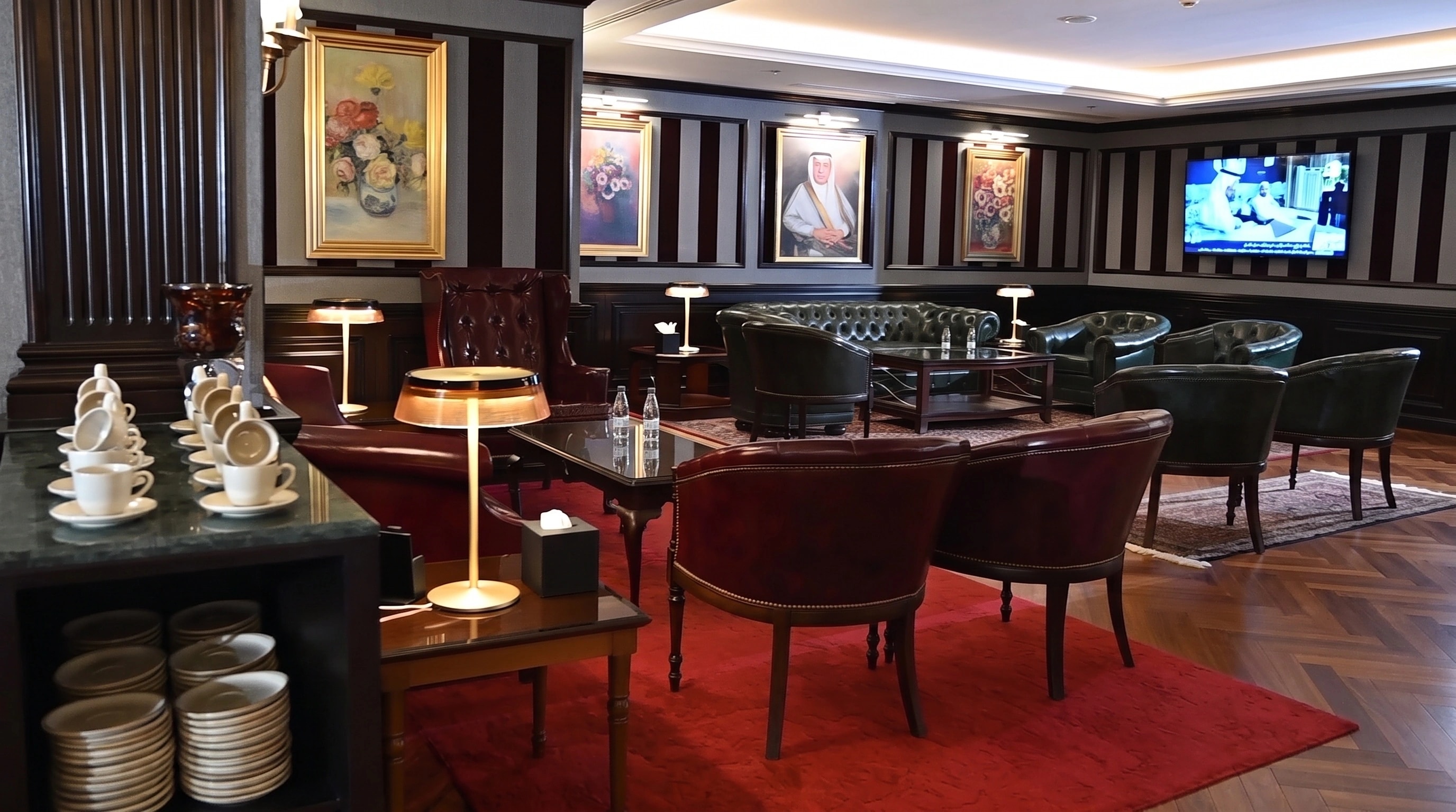 A panelled executive lounge in chevron parquet, seating in deep leather