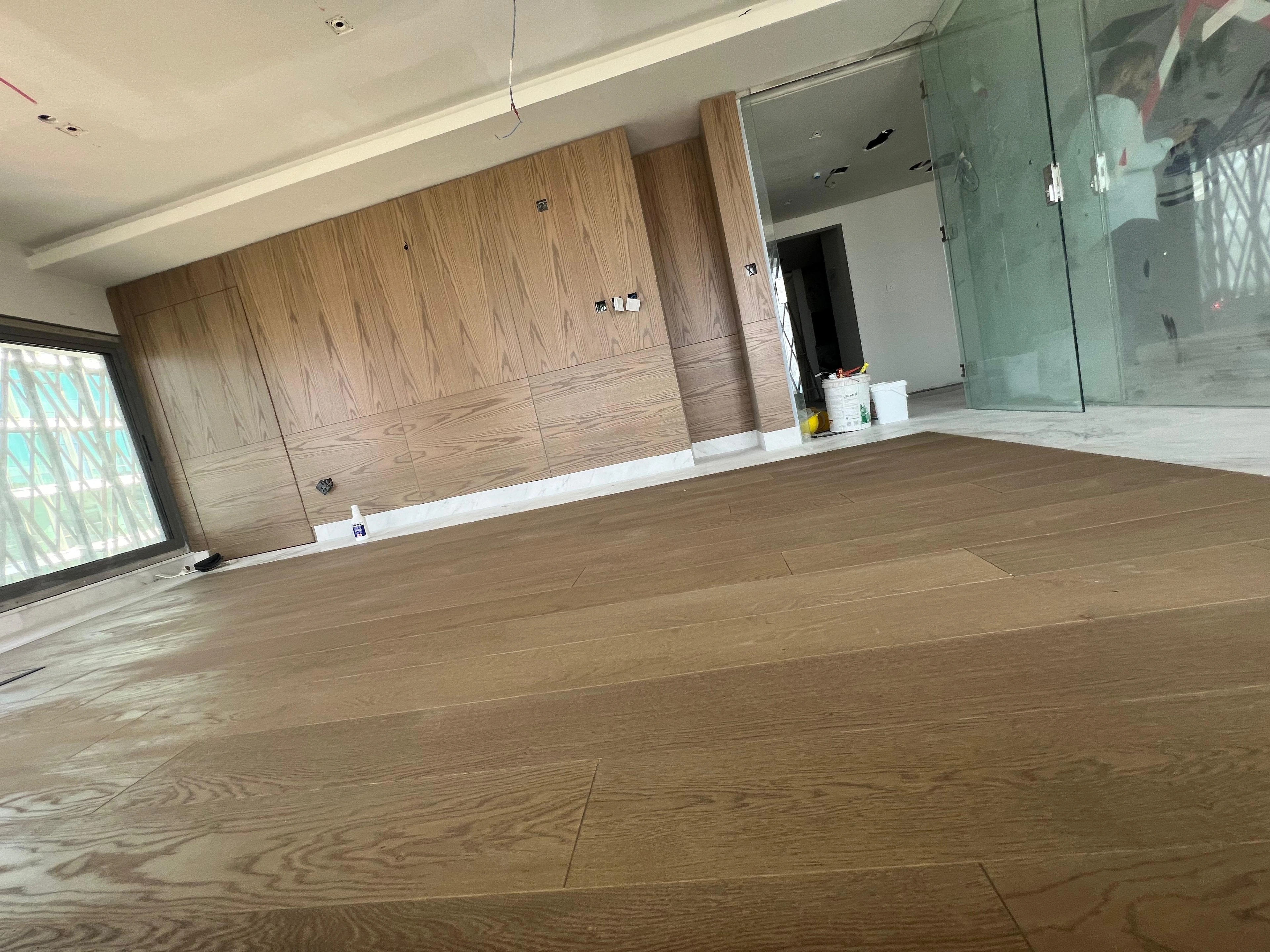Wide-plank oak set within a pale marble perimeter