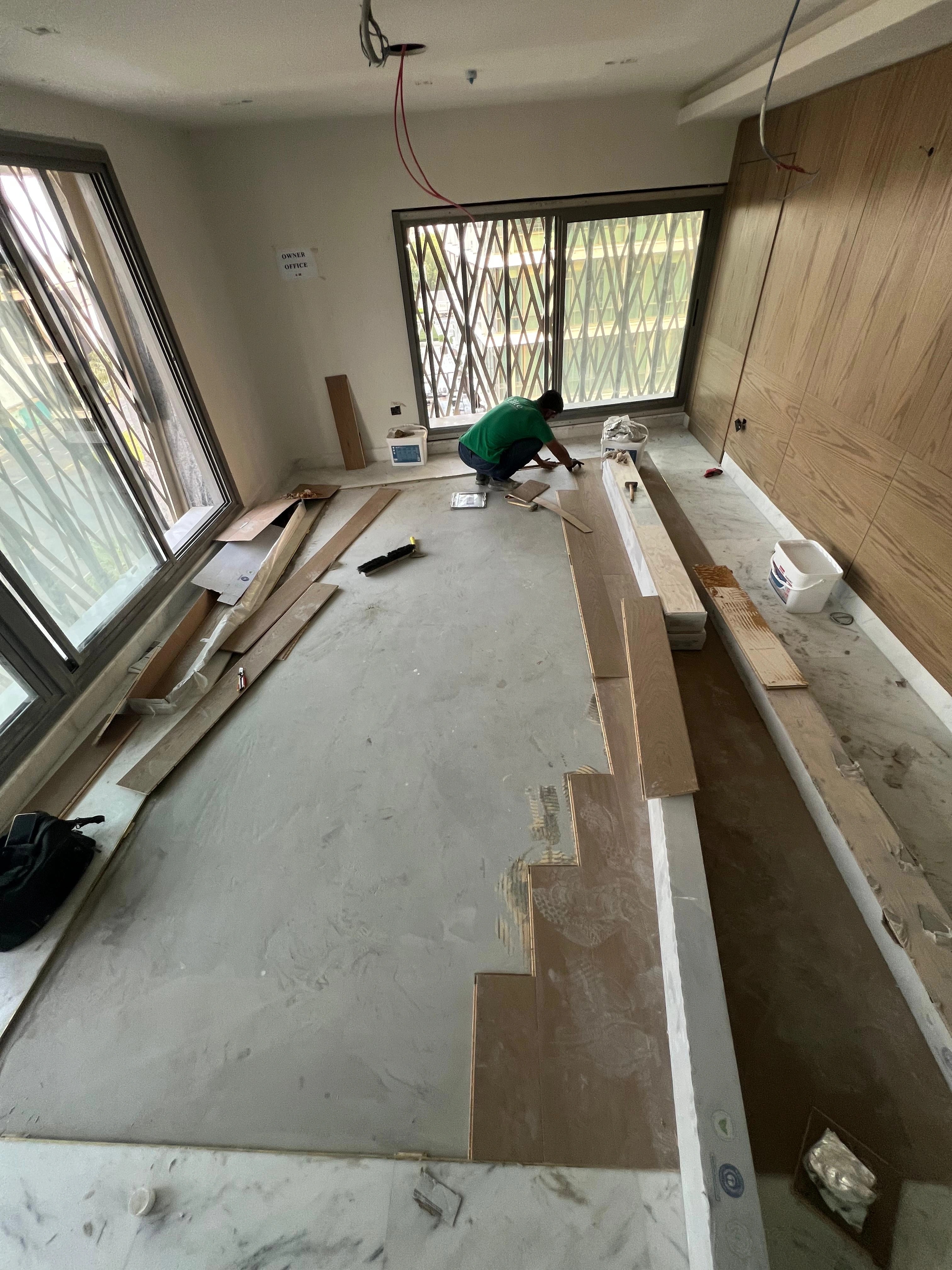 Laying the first wide oak boards inside the marble frame
