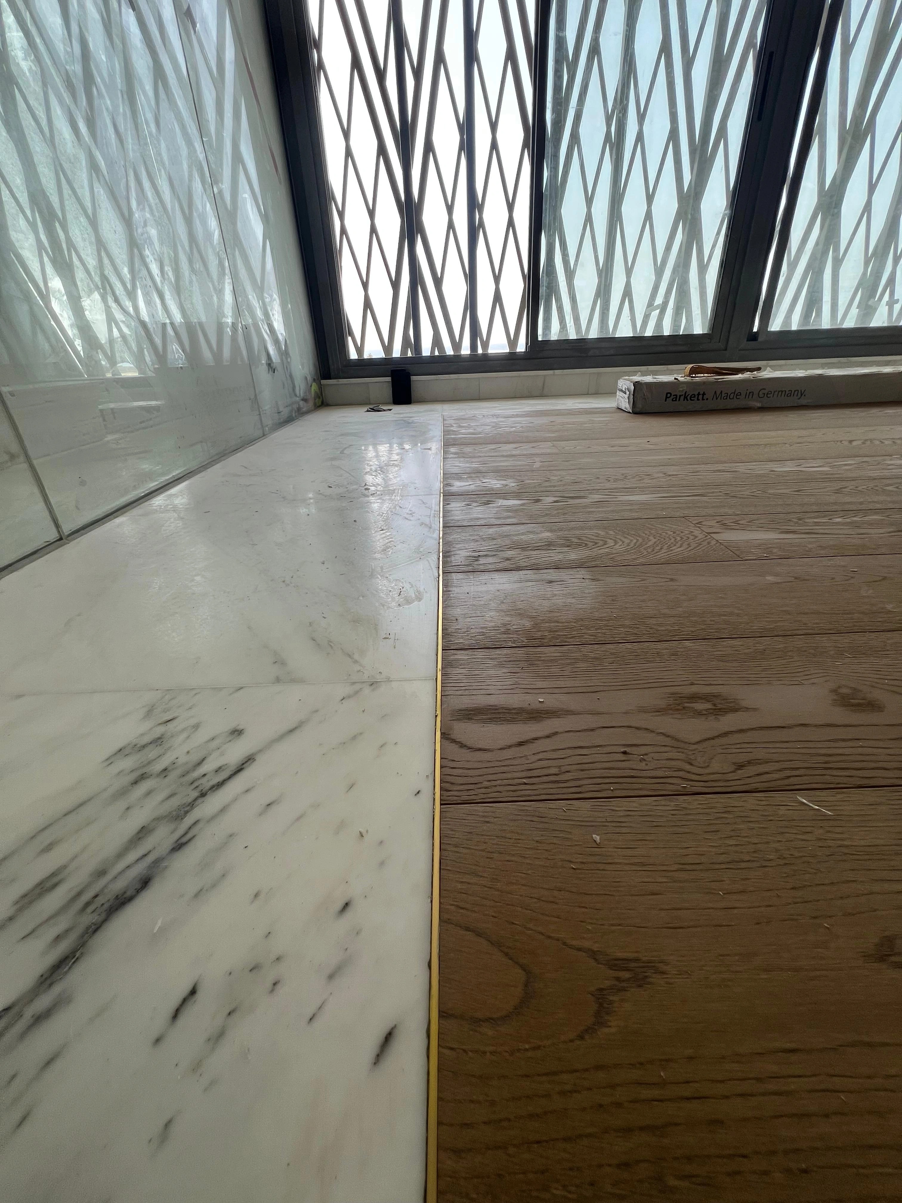Close detail of natural oak meeting the stone threshold