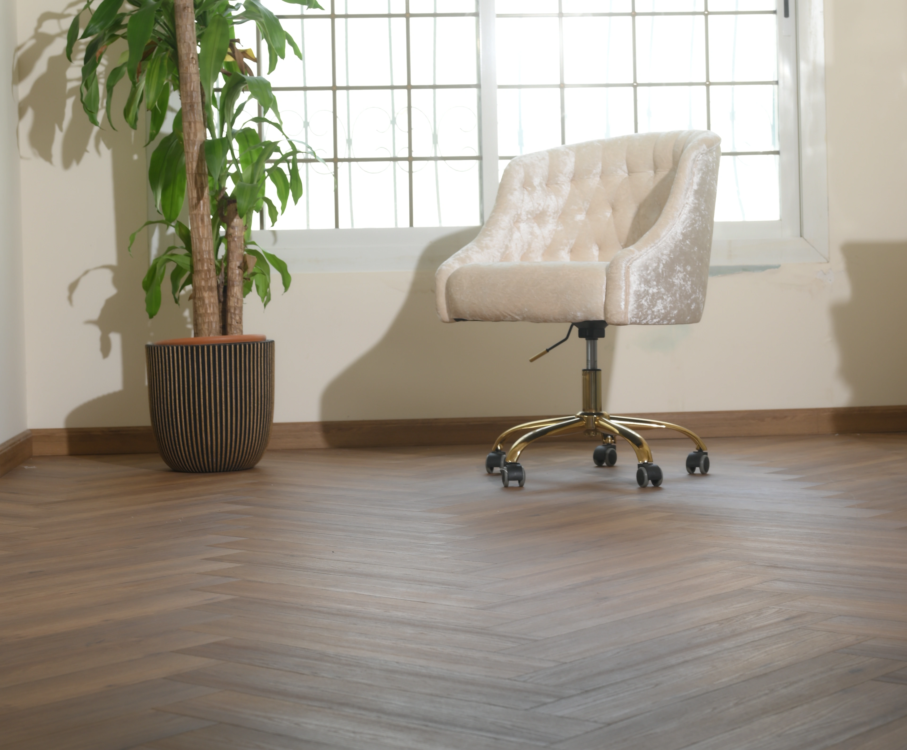 Herringbone oak running the length of a bright reception room