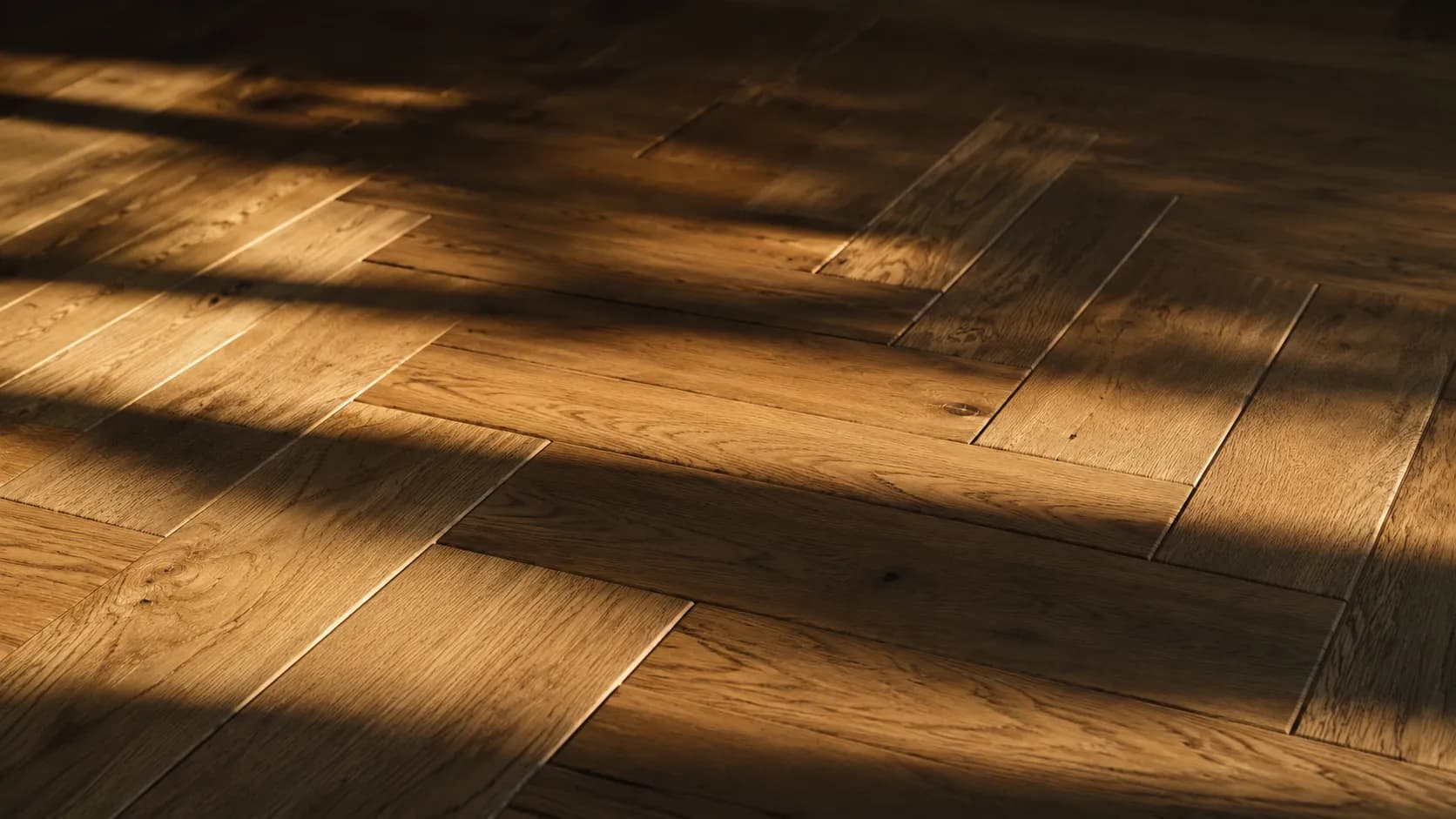 Shafts of daylight raking across herringbone oak