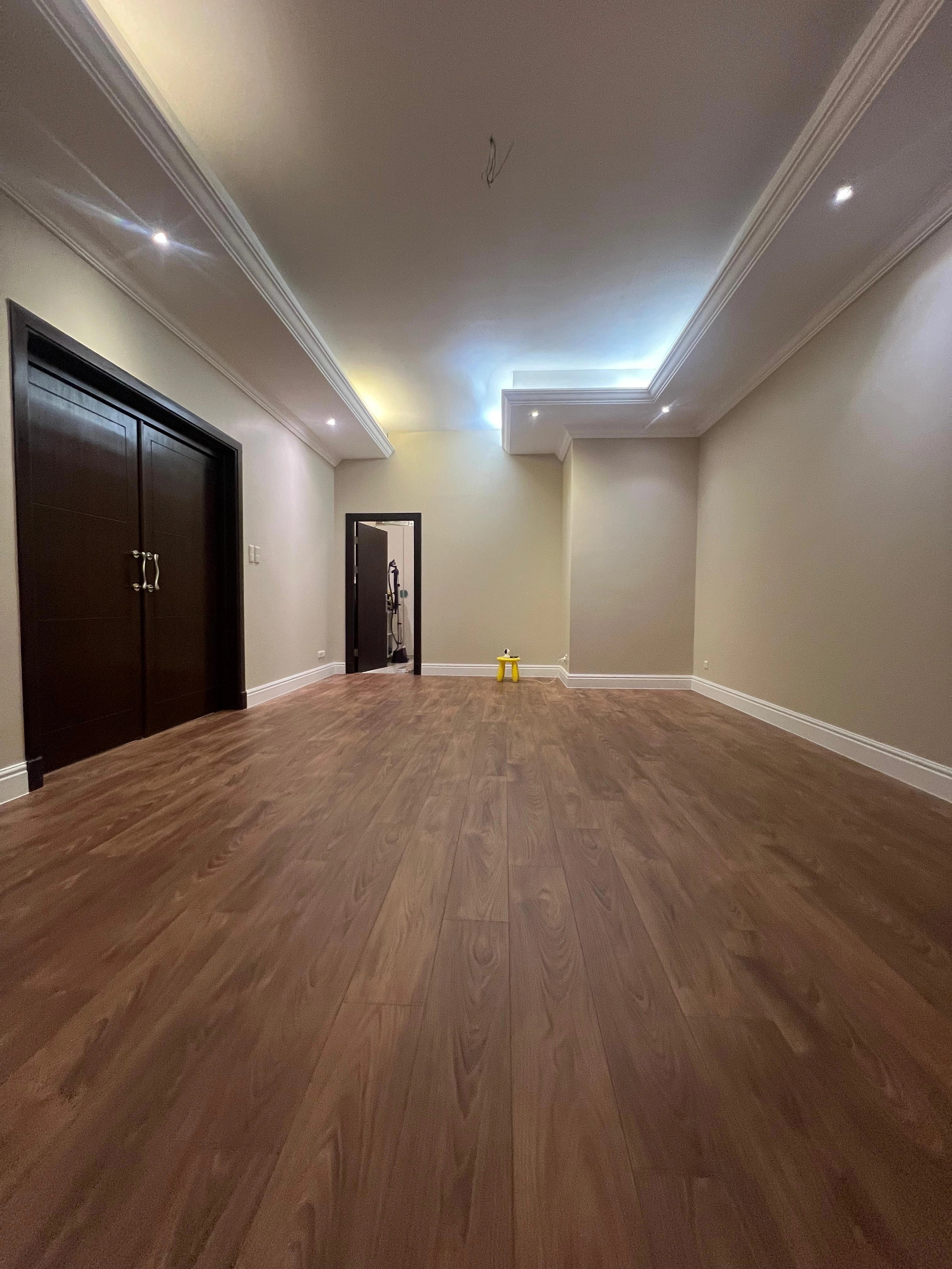 Warm straight-plank oak running the full length of a private room